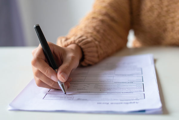 Woman writing with a pen and paper