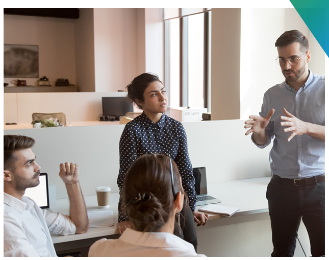 Four people talking in an office