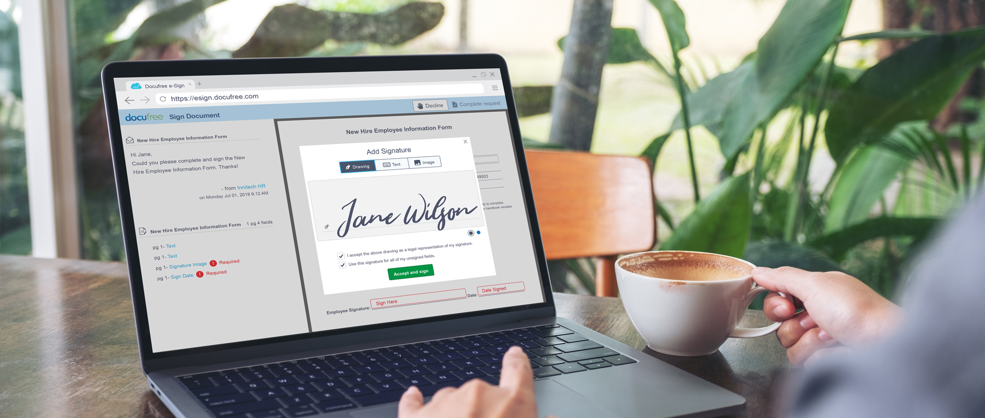 Person using their laptop to sign a document online at a cafe